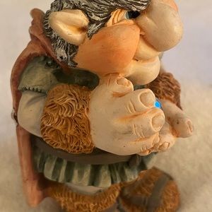 Krystonia Man with grey hair and blue eyes with brown wear ceramic